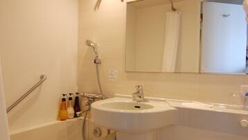 A bathroom with a bathtub, a sink, and a toilet.