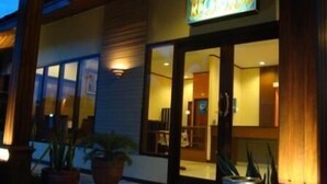 A hotel entrance with a sign that reads "RECEPTION". - Luxio Hotel Sorong (Sorong)