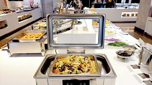 A buffet setup with various food items and utensils. - HiYesHotel - Hualien (Hualien City)