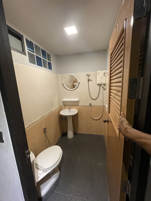 A small bathroom with a toilet, sink, and shower. - Fairyland Resort Koh Samui (Koh Samui)