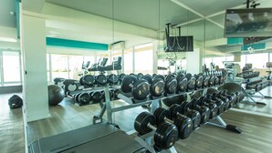 A gym with exercise equipment, including dumbbells and treadmills. - Atlantis Residence - Huge Saltwater Waterpark, Gym & Kids Playground - Free Parking (Pattaya)