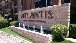 A sign for 'Atlantis Condo Resort Pattaya' with a water feature in front. - Atlantis Residence - Huge Saltwater Waterpark, Gym & Kids Playground - Free Parking (Pattaya)
