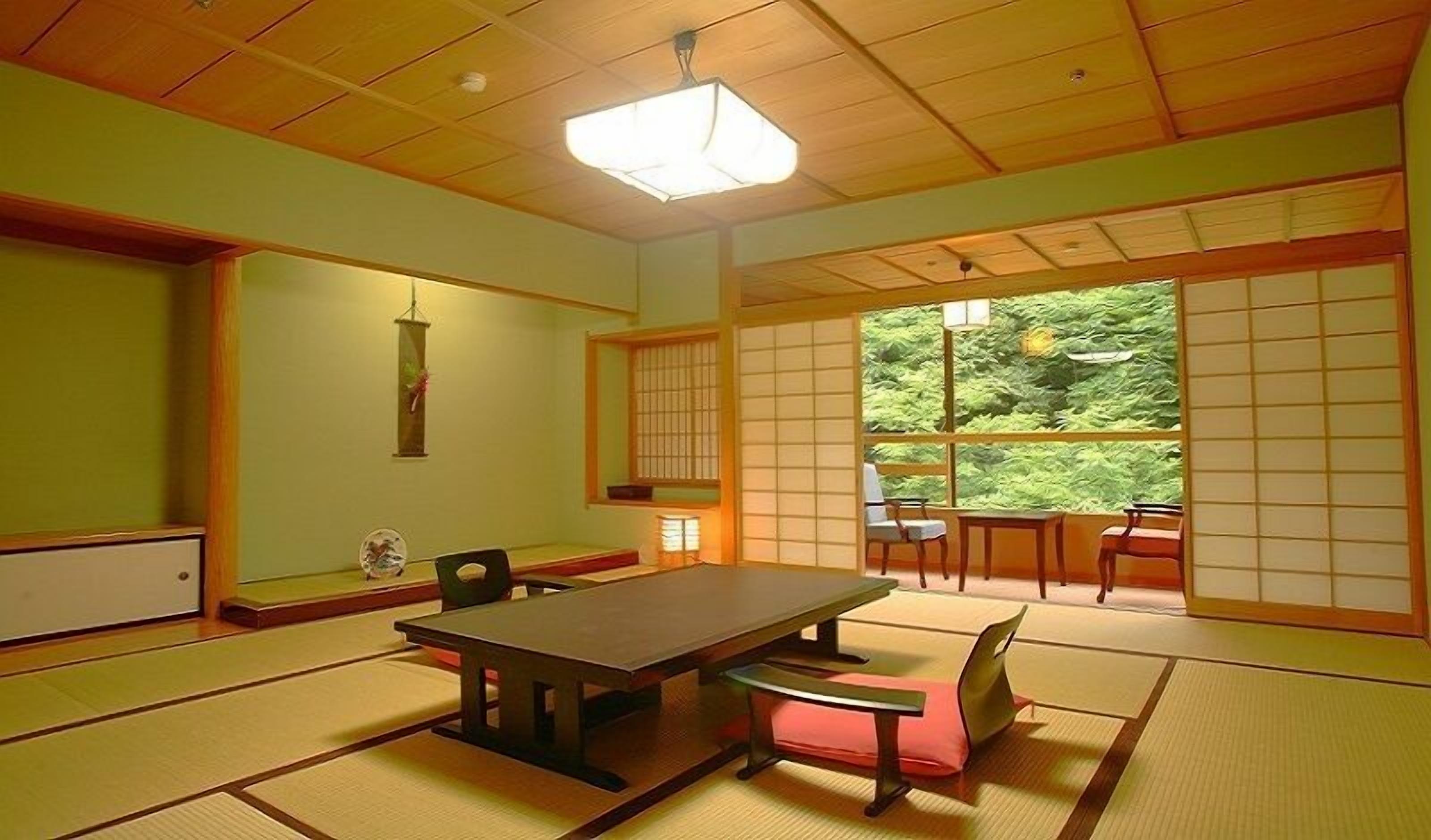 A traditional Japanese room with tatami flooring, a low table, and sliding shoji doors.