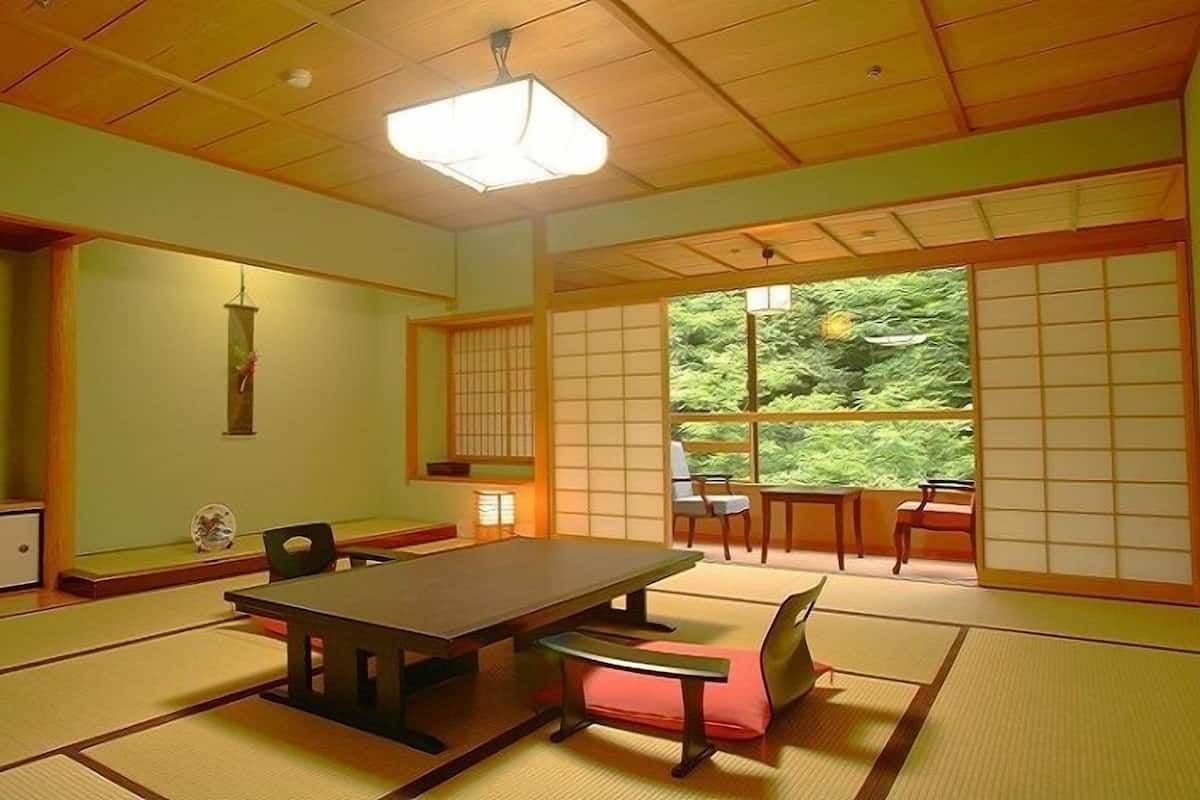 A traditional Japanese room with tatami flooring, a low table, and sliding shoji doors.