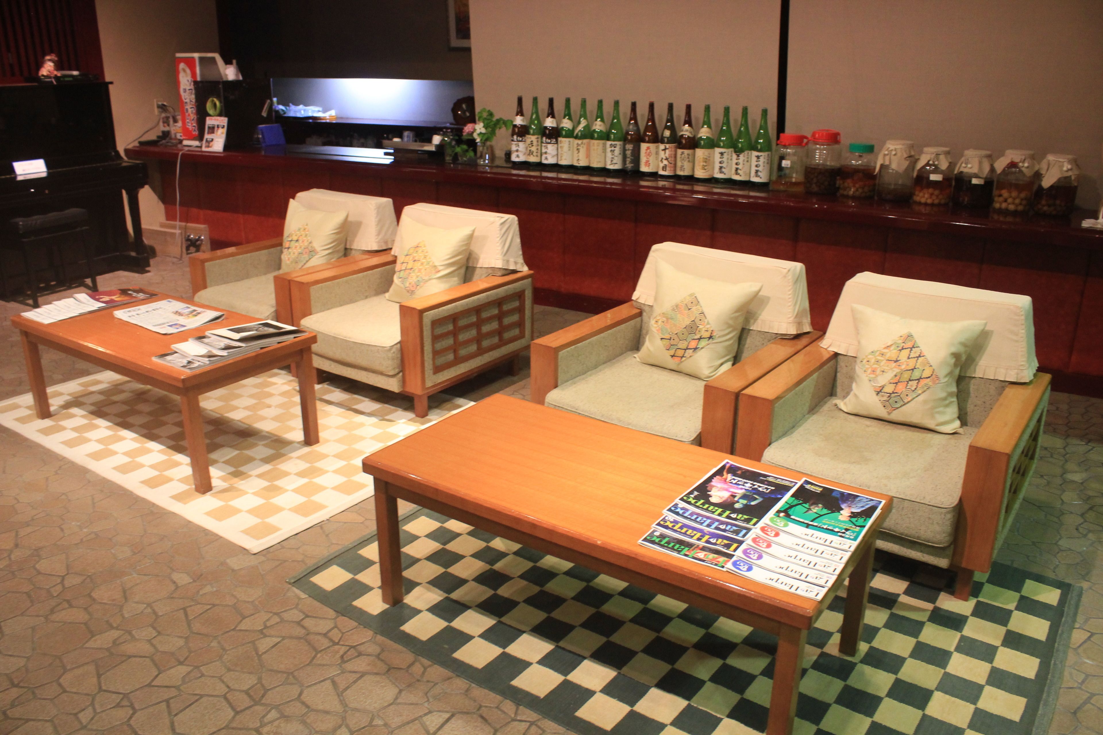 A bar area with seating, a piano, and a television.