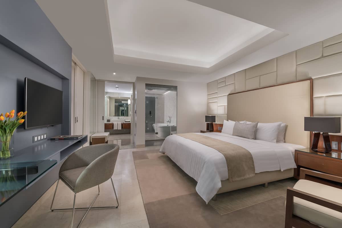 one bedroom suite | premium bedding, in-room safe, desk, laptop workspace