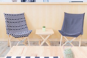 Two patterned chairs with a small table and a cactus between them. - M2 Hotel (Phayao)