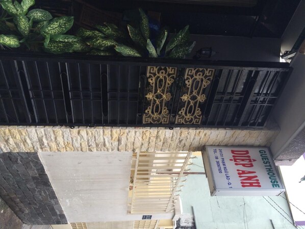 A hotel sign with a decorative metal gate and a stone wall.