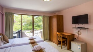 A hotel room with two beds, a desk, a television, and a refrigerator. - Mukanda Residence (Krabi)