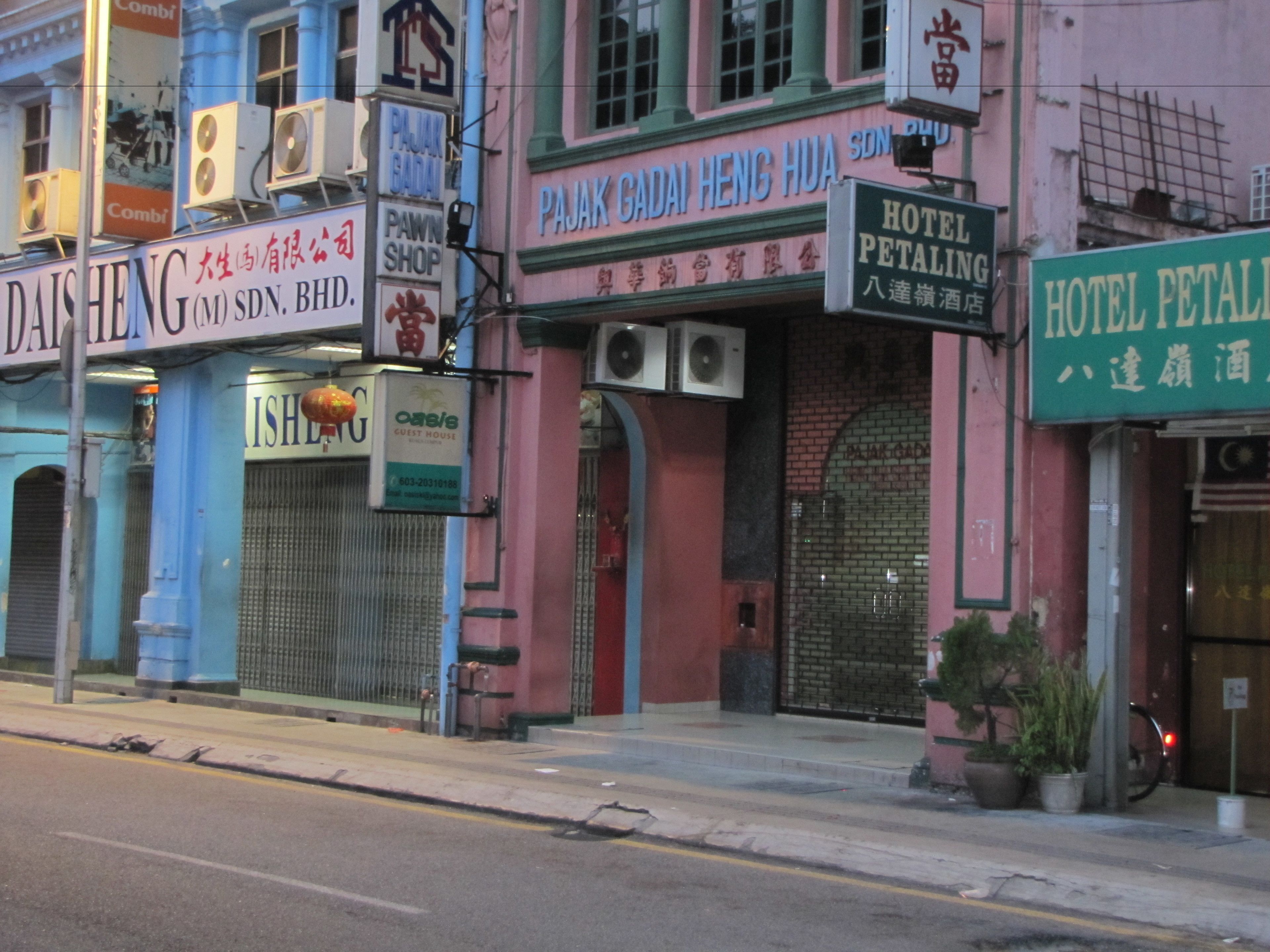 A street view with multiple buildings, including a hotel named 'Hotel Petaling' and a pawn shop.