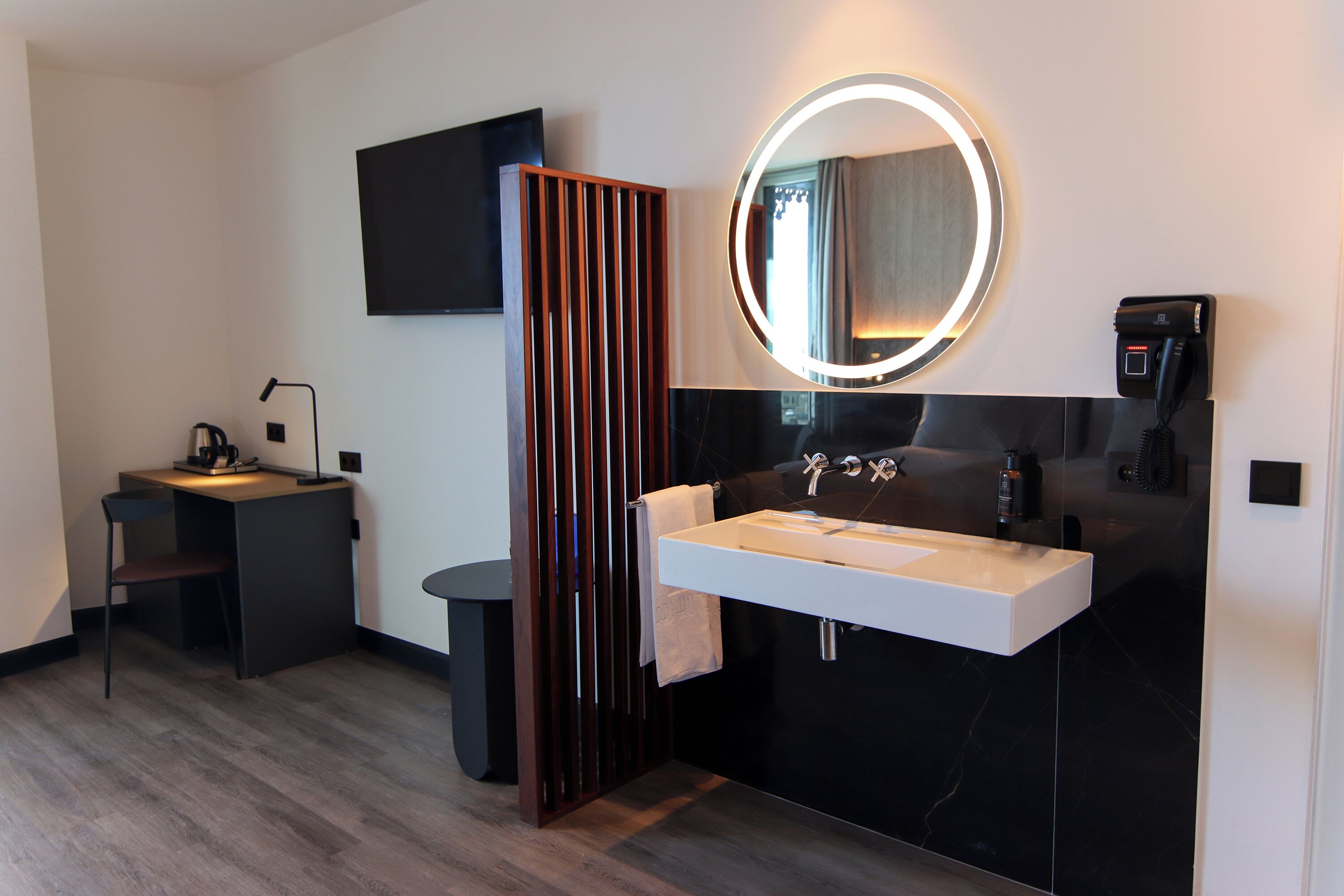 A modern bathroom with a vanity, sink, and mirror.