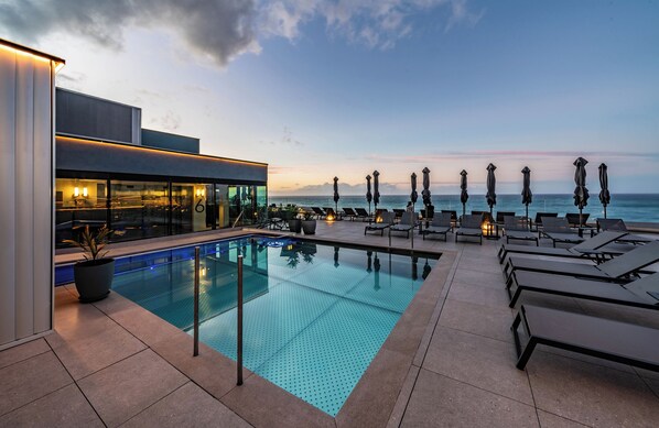 Outdoor pool, open 10:00 AM to 6:00 PM, pool umbrellas, pool loungers