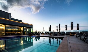 Outdoor pool, open 10:00 AM to 6:00 PM, pool umbrellas, pool loungers