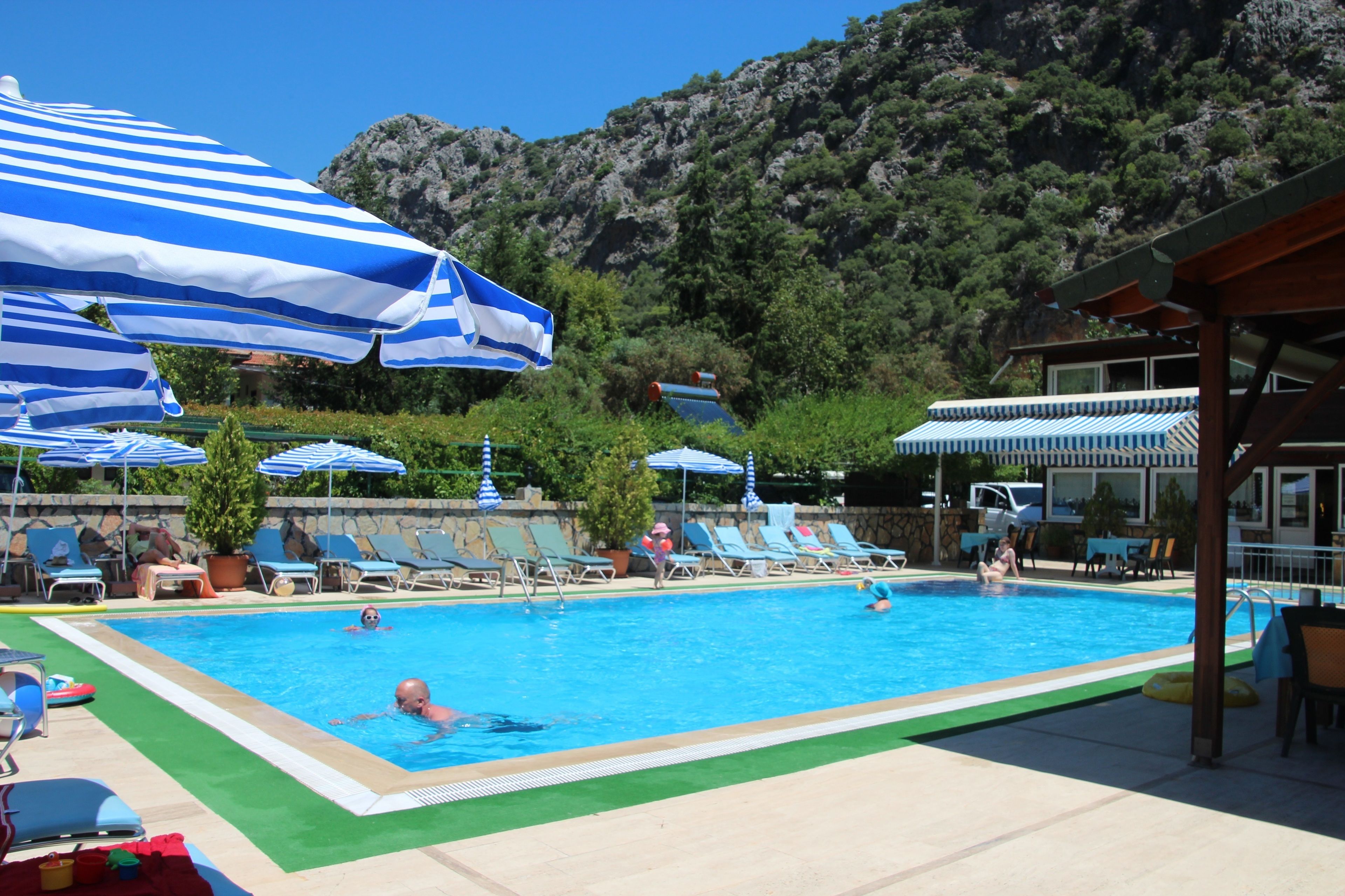 outdoor pool, open 9:00 am to 6:00 pm, pool umbrellas, pool loungers