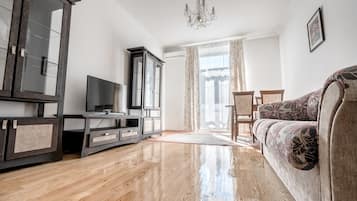 Elite Apartment, 1 Bedroom | Living room | 42-inch LCD TV with cable channels, TV, first-run movies