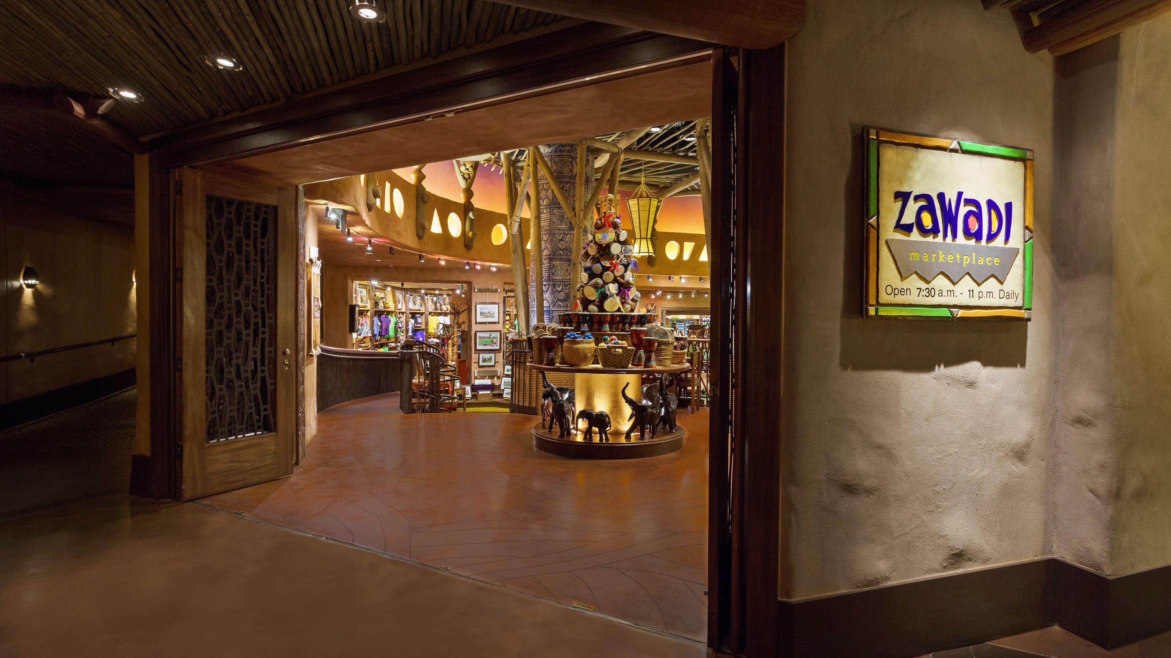 A marketplace with a sign reading "Zawadi marketplace" and a variety of items on display.