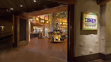 A marketplace with a sign reading "Zawadi marketplace" and a variety of items on display.