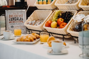 A breakfast buffet with various food items and beverages.