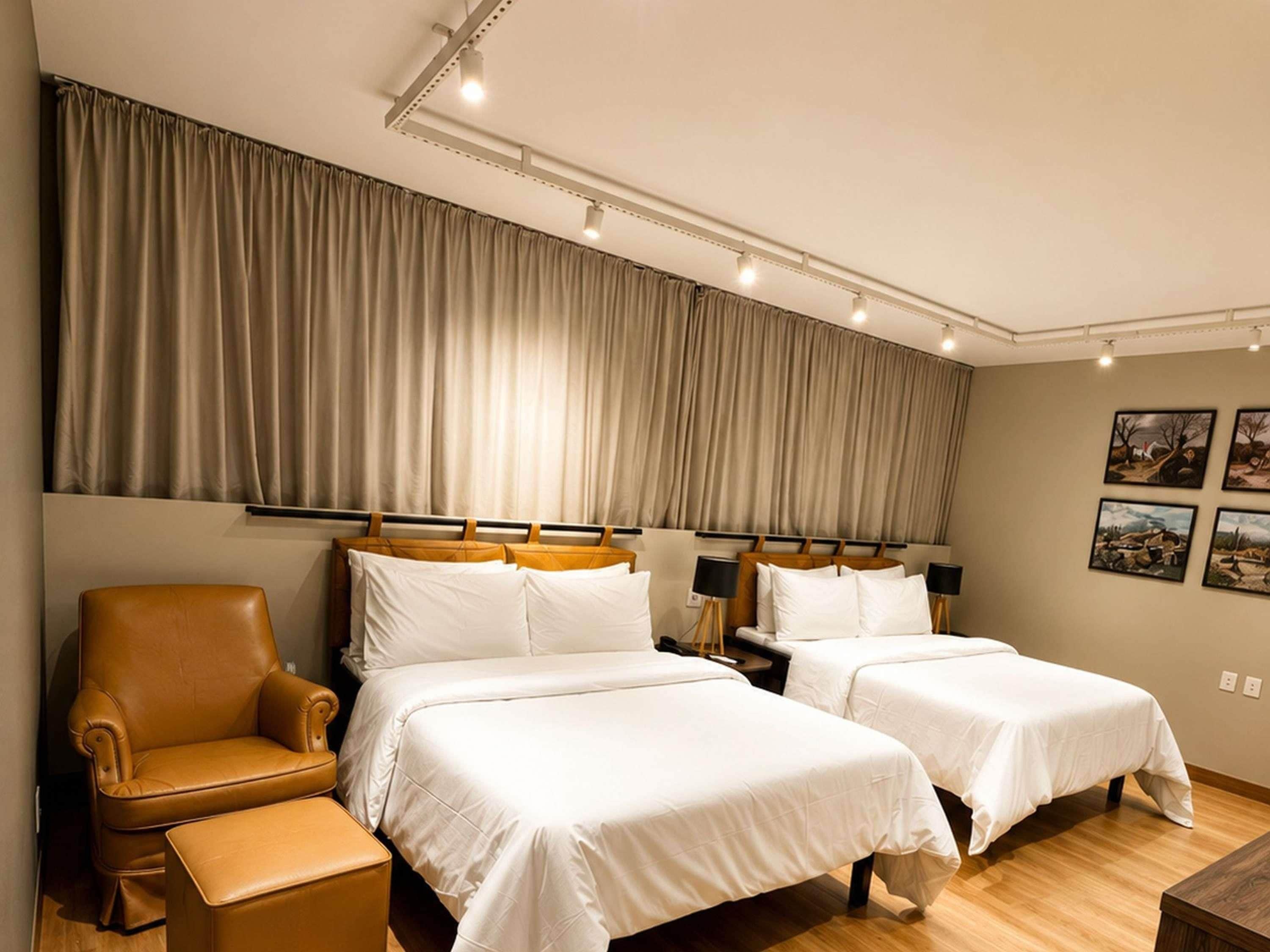 Ein Hotelzimmer mit zwei Betten, einer Couch und einem Sessel.