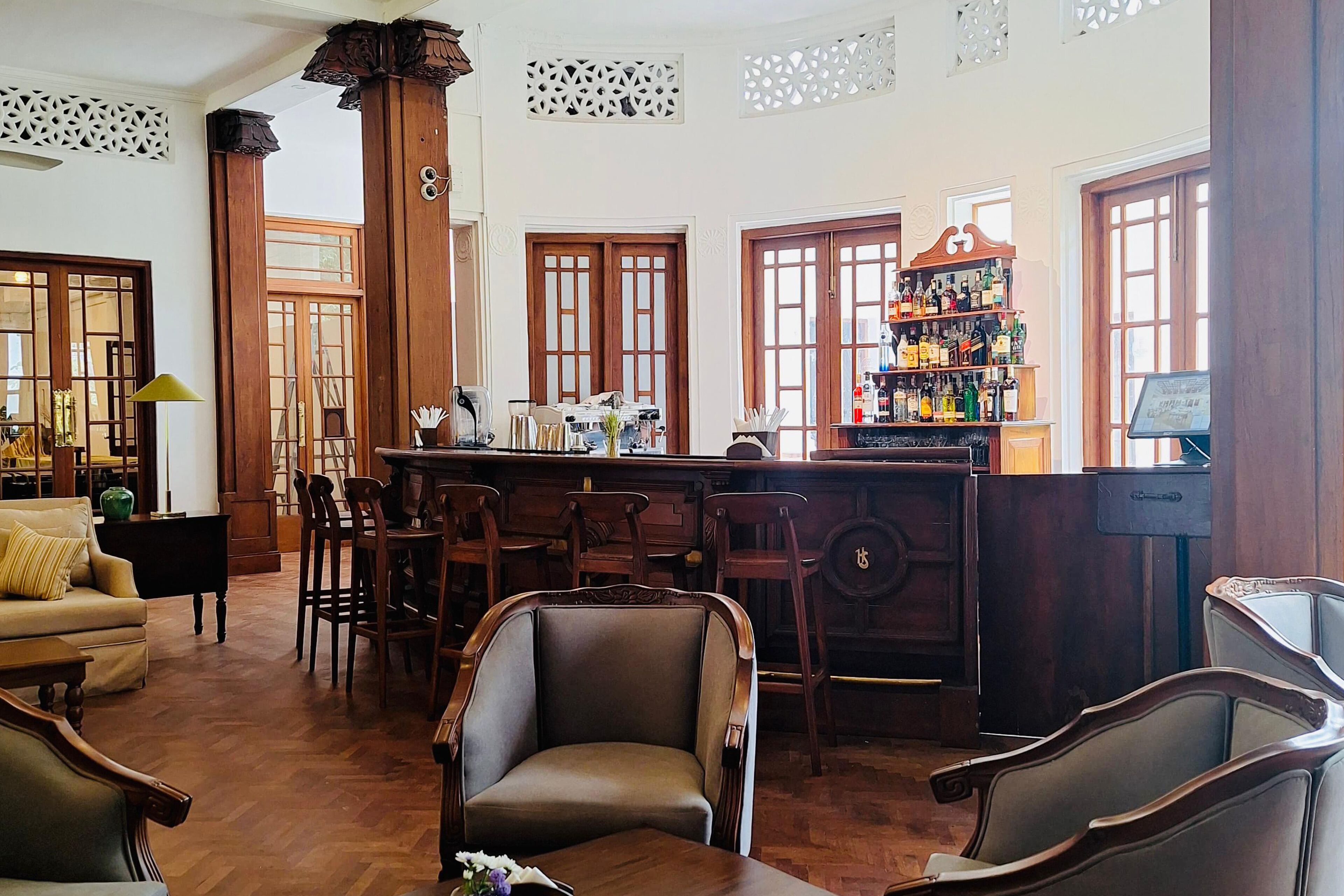 A traditional bar area with wooden furniture and a bar counter.