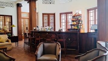 A traditional bar area with wooden furniture and a bar counter.