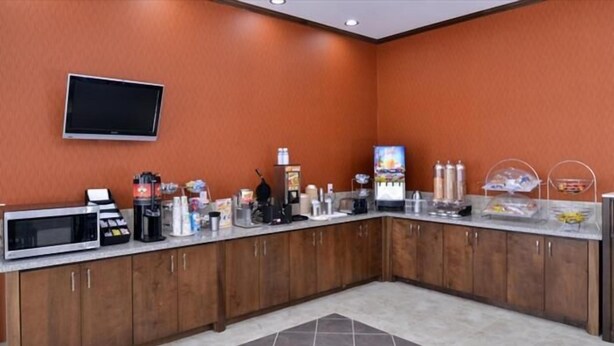 A kitchen with a microwave, coffee maker, and various appliances. - La Bonita Inn & Suites (Crane)