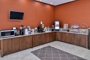 A kitchen with a microwave, coffee maker, and various appliances. - La Bonita Inn & Suites (Crane)