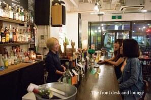 A bar area with a front desk and lounge seating. - Trip Shot Hotels Koza (Okinawa)
