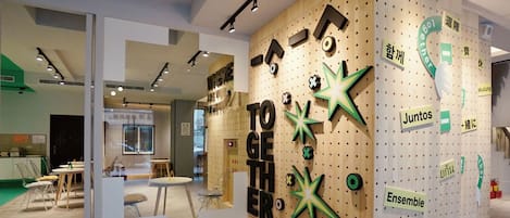 A modern interior with a wooden wall displaying the word "TOGETHER" and various other words.