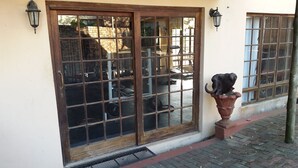 A building with large windows and a metal gate. - iLanga Lodge (St. Lucia)