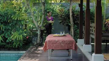 Relax in a serene garden setting, surrounded by lush greenery and a tranquil atmosphere, perfect for dining or leisure.