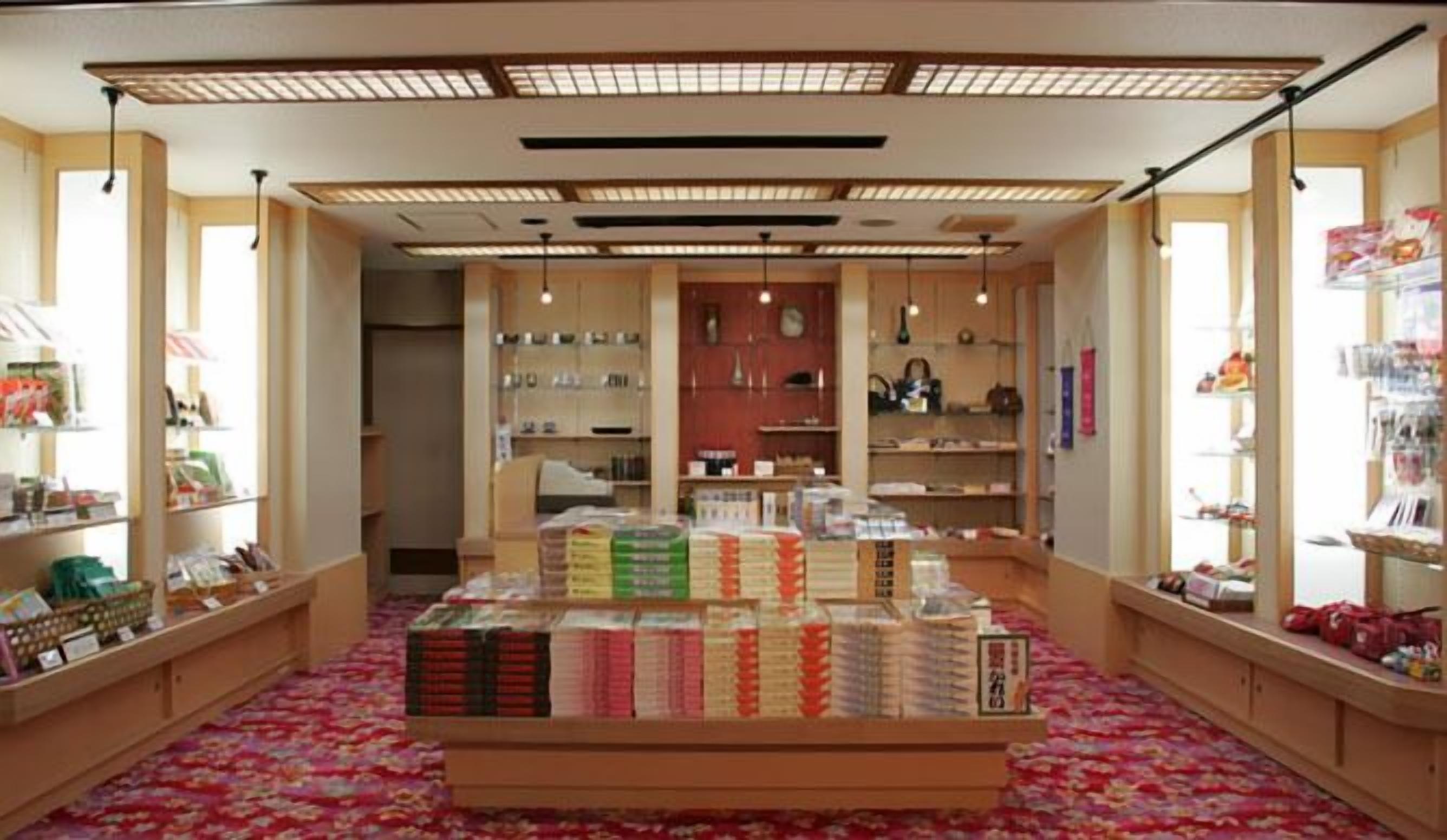 A bookstore with shelves of books and a display of books in the center.
