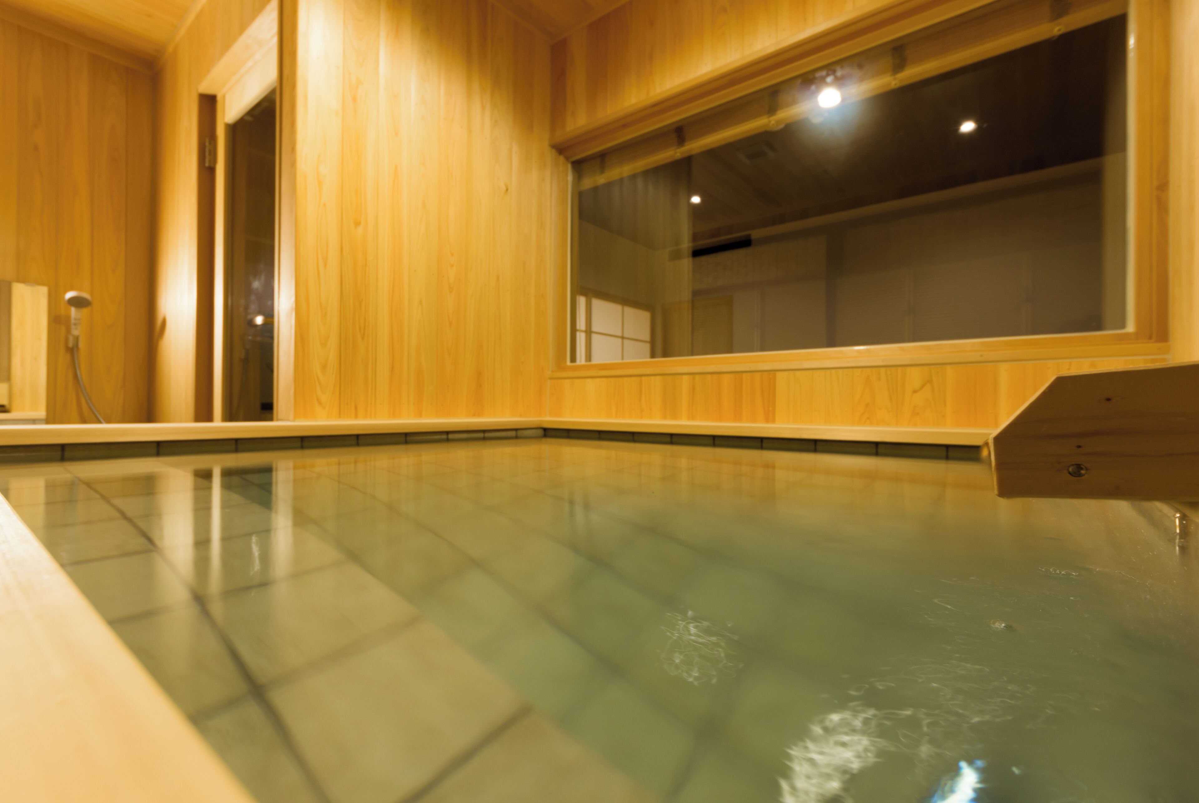 A wooden interior with a glass-enclosed pool.
