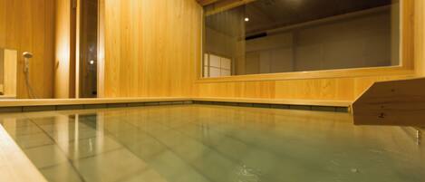 A wooden interior with a glass-enclosed pool.