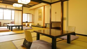 A traditional Japanese room with tatami mats, low tables, and sliding doors. - Yamashiro Onsen Ryokan Tatami (Kaga)