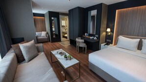 A modern hotel room with a sofa, a bed, a desk, and a chair. - Hotel Bosfora (Istanbul)