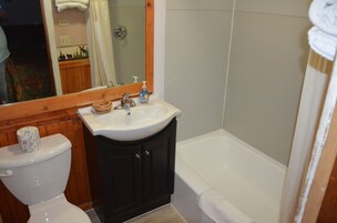 Standard Room, 1 King Bed | Bathroom | Combined shower/tub, hair dryer, towels