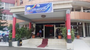 Welcome to a warm and inviting entrance, featuring a grand banner and elegant pillars.
