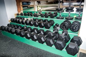 Stay fit on the go with our well-equipped gym featuring a range of weightlifting equipment.
