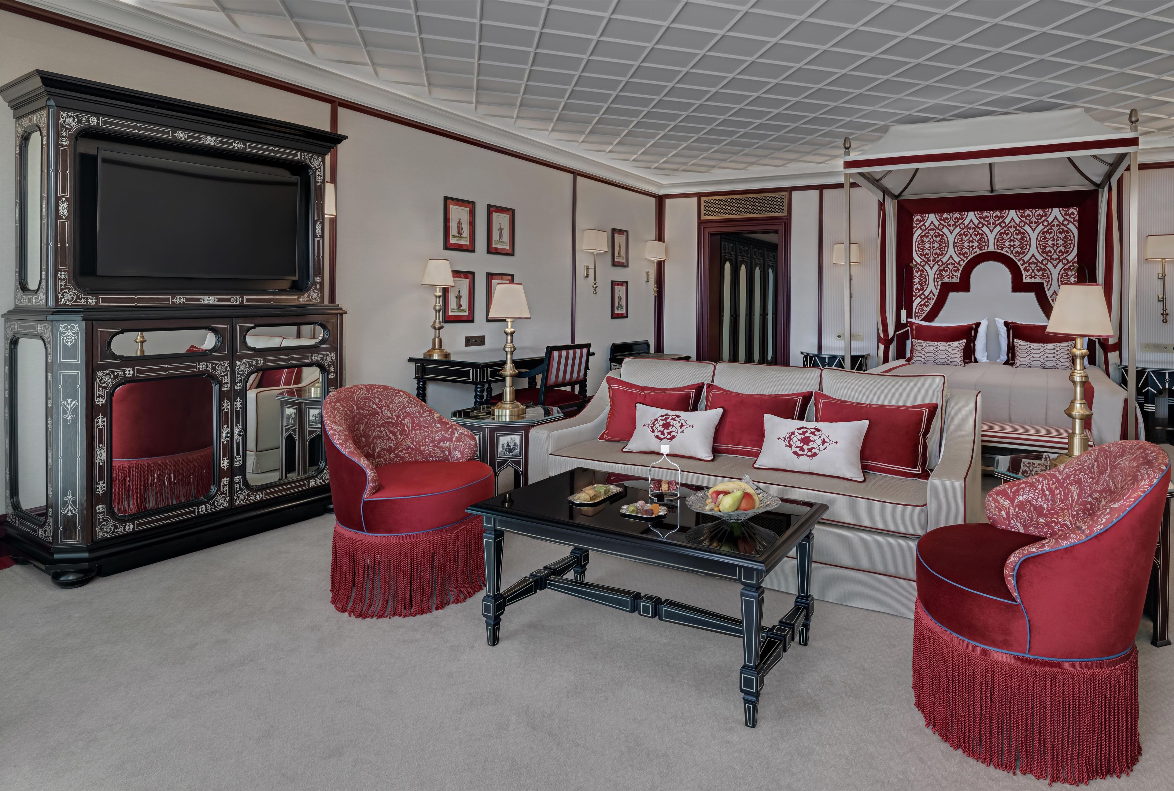 A traditional living room with a television, a sofa set, and a coffee table.