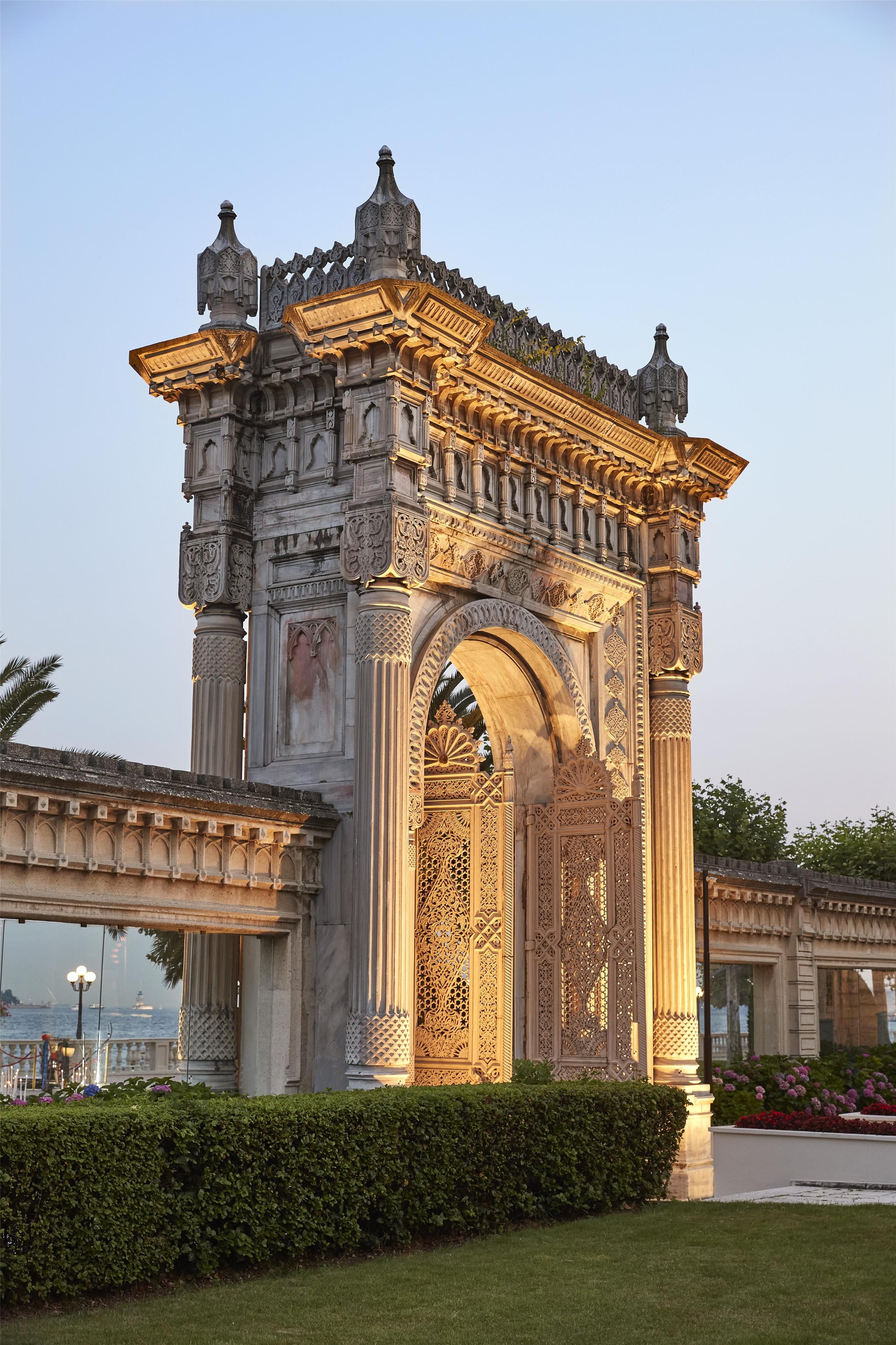 A large stone archway with intricate carvings and a decorative roof.