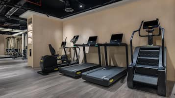 A gym with treadmills, elliptical machines, and a stair climber.