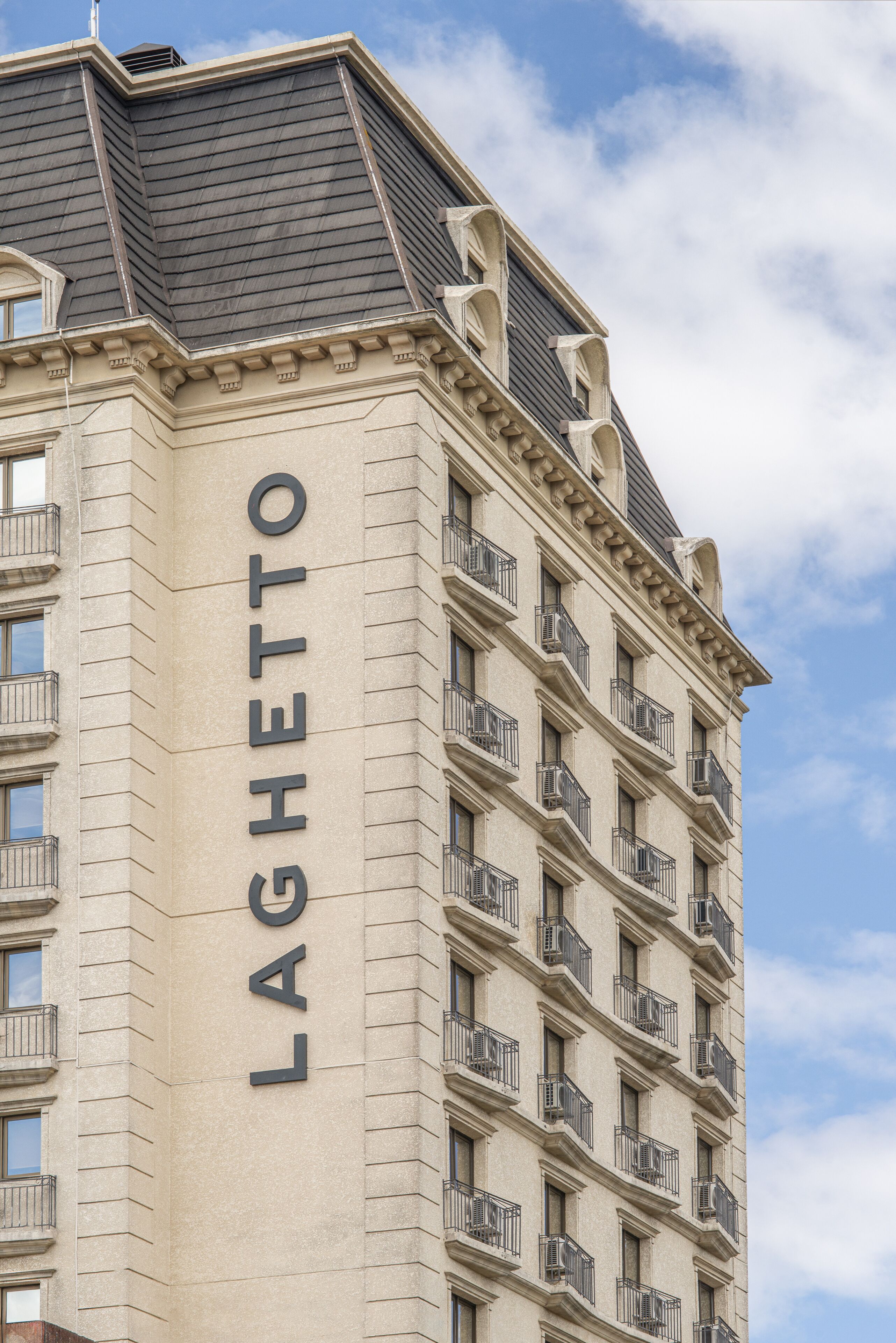 A tall building with the name "LAGHETTO" prominently displayed on its facade.