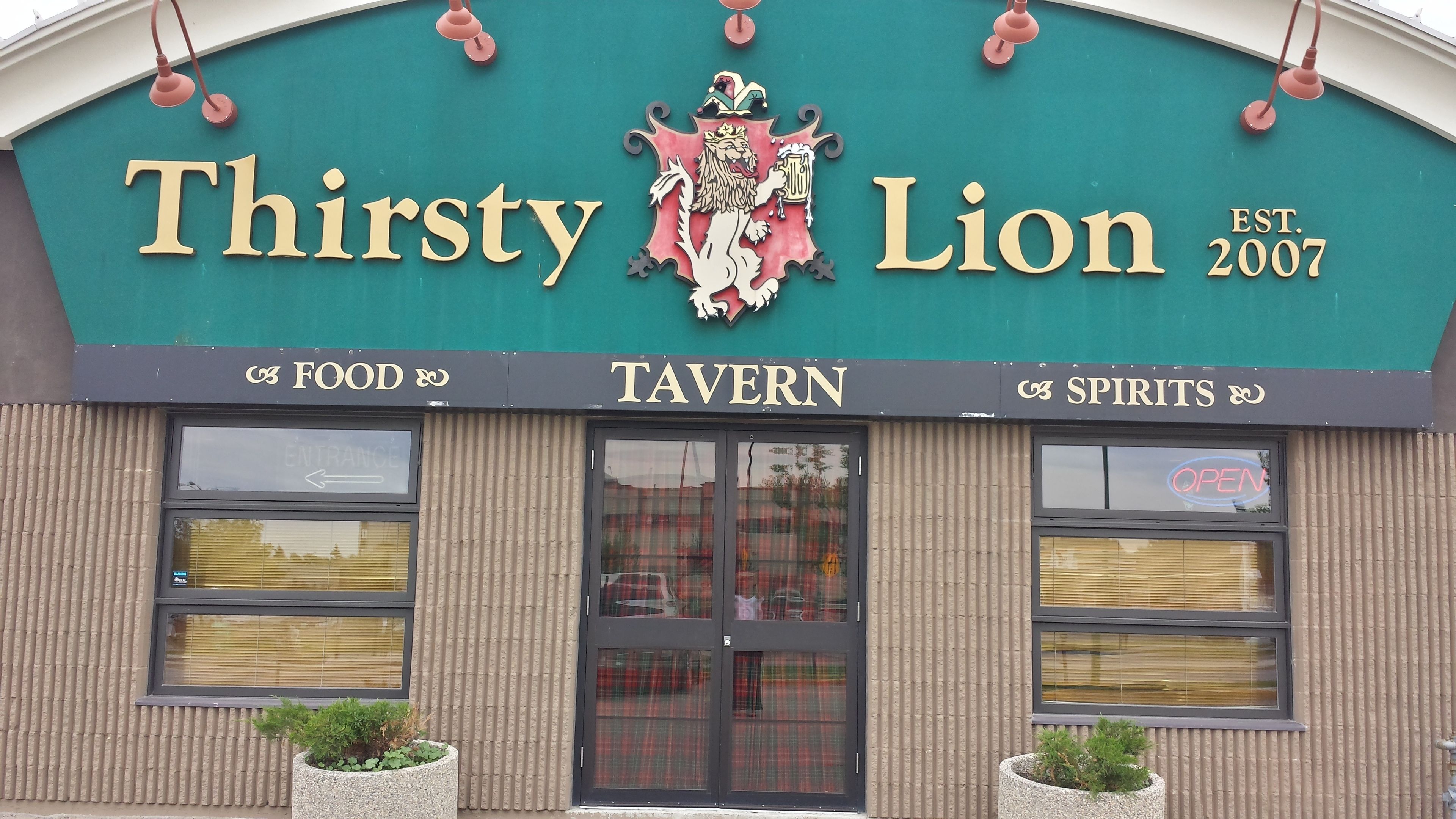 A tavern named "Thirsty Lion" with a crest logo, established in 2007.