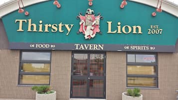 A tavern named "Thirsty Lion" with a crest logo, established in 2007.