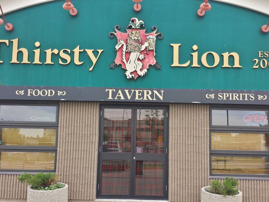 A tavern named "Thirsty Lion" with a crest logo, established in 2007.
