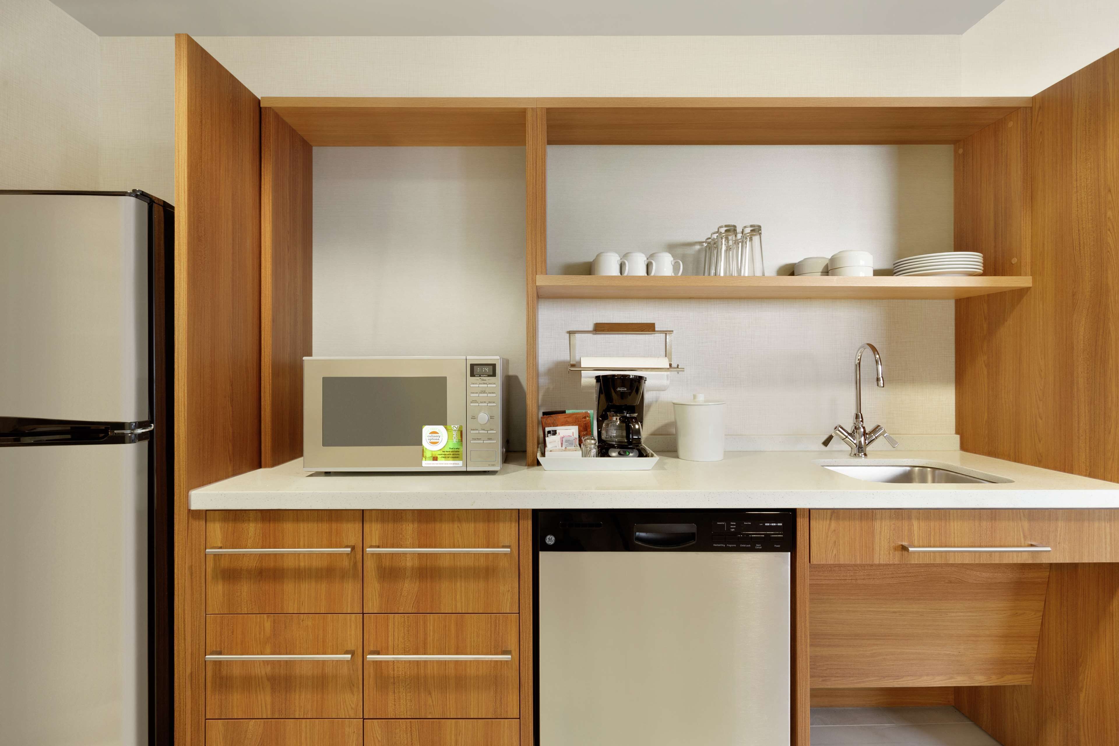 full-sized fridge, microwave, dishwasher, cookware/dishes/utensils