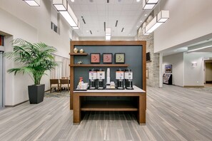 Welcome to our lobby, featuring a reception desk, coffee station, and comfortable seating area.
