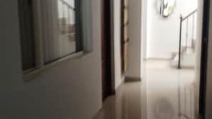 A hallway with a window and a door leading to a staircase. - Hotel Casa La Embajada Colonial (Bogotá)