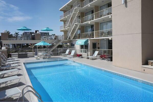 Seasonal outdoor pool, open 9:00 AM to 8:00 PM, pool umbrellas